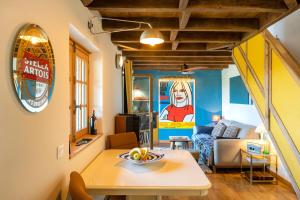 a living room with a table and a couch at L'Atelier de Scarlett - Lannux in Lannux