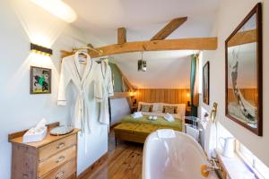 a bedroom with a bed and a sink and a tub at L'Atelier de Scarlett - Lannux in Lannux +22 photos