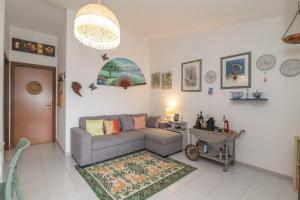 a living room with a couch and a table at Rosemary House in Olbia