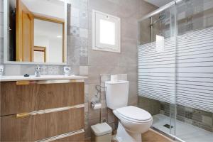 a bathroom with a toilet and a sink and a shower at Casa Cactus in Antigua +19 photos
