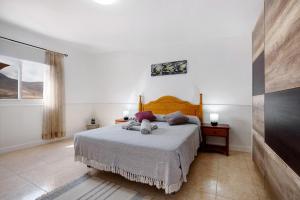 a bedroom with a bed in a white room at Casa Cactus in Antigua