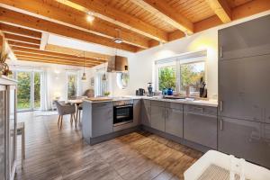 a kitchen with stainless steel appliances and a dining room at Wildrosenhaus in Kosel