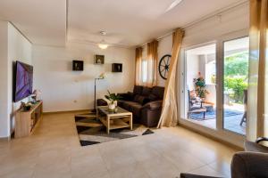 a living room with a couch and a tv at Luxury Pool and Spa - Casa Coco in Casas del Cura