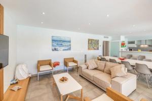 a living room with a couch and a table at Gemelos in Alcudia