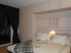 a bedroom with a bed with white sheets and pillows at Alb Studio in Sankt Blasien in St. Blasien