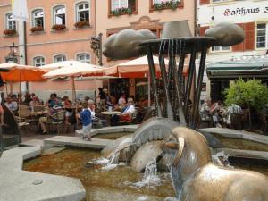 a fountain in a city with people sitting at tables at Alb Studio in Sankt Blasien in St. Blasien