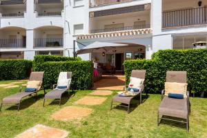 a group of chairs and an umbrella in the grass at Luxury Pool and Spa - Casa Coco in Casas del Cura