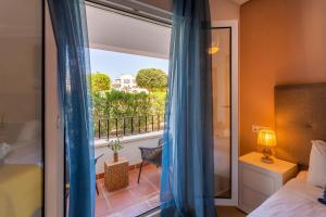 a bedroom with a balcony with a bed and a window at Luxury Pool and Spa - Casa Coco in Casas del Cura +19 photos