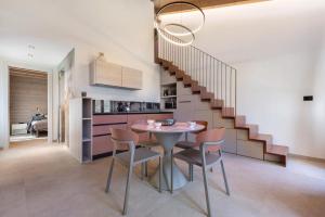 a dining room with a table and chairs and a staircase at Casa Meg in Tremosine Sul Garda +44 photos