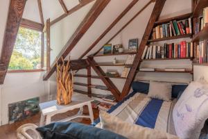 a room with a bed and a book shelf at Charmante Bergerie in Castet