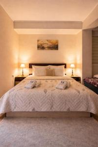 a bedroom with a bed with two towels on it at Mitrovi Apartment in Gevgelija