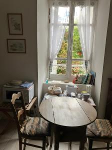 a table and chairs in a room with a window at Keranroux 315 - Île de Bréhat in Bréhat