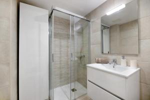 a white bathroom with a shower and a sink at Casa Joyne in Puerto del Carmen +12 photos