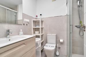 a bathroom with a toilet and a sink and a shower at Apartamento Familiar Torrox A65 in Torrox +15 photos