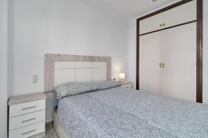 a bedroom with a bed and a dresser and a mirror at Apartamento Familiar Torrox A65 in Torrox