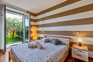a bedroom with a bed and a large window at Bluemoon Luminoso apt con piscina in Lazise