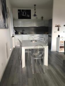 a kitchen with a white table and chairs at Villa Su 3 Piani Con Giardino in Lido di Spina +34 photos