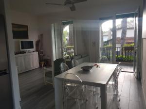 a living room with a table and chairs and a television at Villa Su 3 Piani Con Giardino in Lido di Spina
