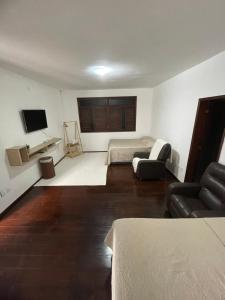a living room with a bed and a couch at Star HOUSE beach in Aracaju