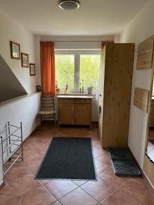 a room with a kitchen with a sink and a window at Ferienwohnung Moos-Hochsauerland in Olsberg +14 photos
