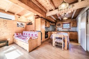 a kitchen with wooden walls and a table with a bench at Chalet 6p Premium - La Bergeronette in Verchaix
