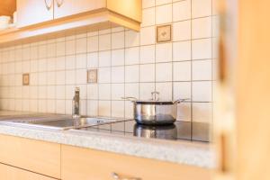 a pot on a stove in a kitchen at Kuglerhof Apt 1 in Cadipietra