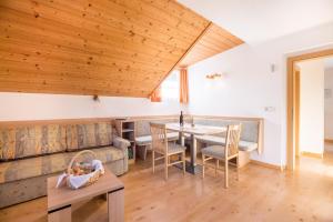 a living room with a couch and a table at Kuglerhof Apt 1 in Cadipietra +17 photos