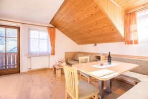 a living room with a table and a couch at Kuglerhof Apt 1 in Cadipietra