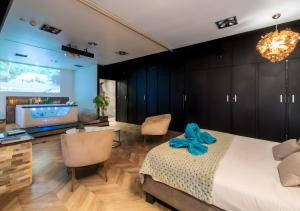 a bedroom with a bed with a blue bow on it at Suite toute équipée Jacuzzi privé in Nîmes