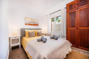 a bedroom with a bed with two pillows on it at Villa Puerto in Sóller +24 photos