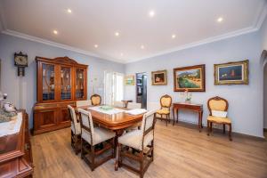 a dining room with a table and chairs at Villa Puerto in Sóller