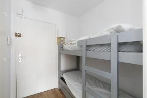 a bedroom with a bunk bed and a door at Appart' Chez Suzi, La Baule centre in La Baule
