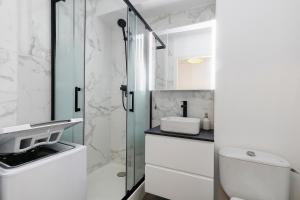 a bathroom with a toilet and a sink and a shower at Appart' Chez Suzi, La Baule centre in La Baule +16 photos