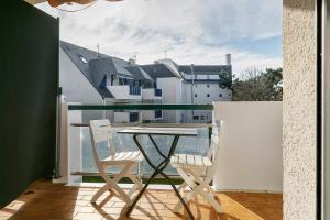 a table and two chairs on a balcony with a view at Appart' Chez Suzi, La Baule centre in La Baule