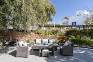 a patio with wicker chairs and a table at San Jose in Nerja