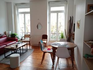 a living room with a table and chairs at T2 bis Vue Aneto in Luchon