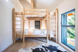 a room with two bunk beds and a window at Black Arves in La Rochette