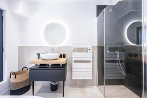 a bathroom with a sink and a mirror at Black Arves in La Rochette +33 photos