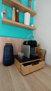 a kitchen with a black counter top and a table at Casa Neptune in Sausset-les-Pins +16 photos