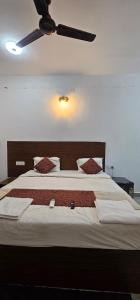 a bedroom with a large bed with a ceiling fan at Hotel blue ocean baga beach away in Arpora