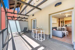 a room with a balcony with a table and a kitchen at Summit Sierra Nevada in Sierra Nevada