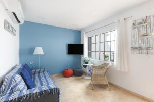 a bedroom with blue walls and a bed and a window at Safir in Son Bou