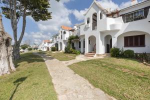 a walkway in front of a white house at Safir in Son Bou