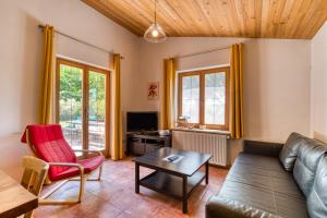 a living room with a couch and a table at Maison Orange in Aspiran