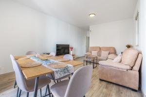 a living room with a table and chairs and a couch at Bright Apartment In Maracena in Granada