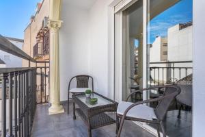 a balcony with chairs and a table on a balcony at Bright Apartment In Maracena in Granada