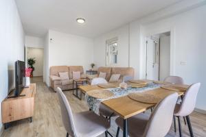 a living room with a table and chairs at Bright Apartment In Maracena in Granada