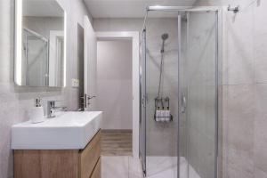 a bathroom with a sink and a shower at Bright Apartment In Maracena in Granada +17 photos