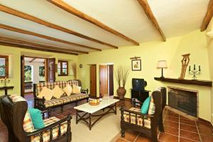 a living room filled with furniture and a fireplace at Quinta da Aroeira in Lagoa
