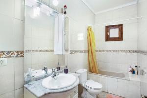 a bathroom with a sink and a toilet and a tub at Villa Palomino in Gáldar +16 photos